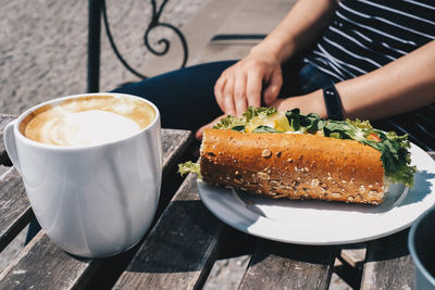 Cropped image of coffee with cup on table