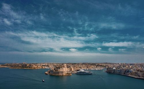 Panoramic view of sea and buildings against sky