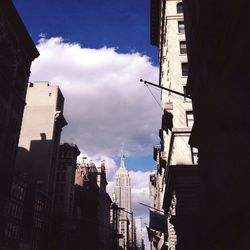 Low angle view of buildings against cloudy sky