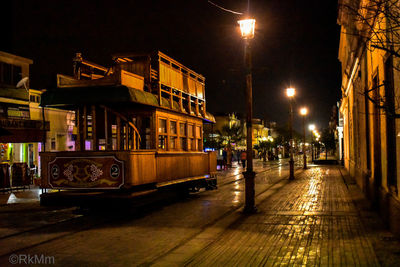 Illuminated city street at night