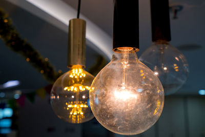 Close-up of illuminated light bulb on table