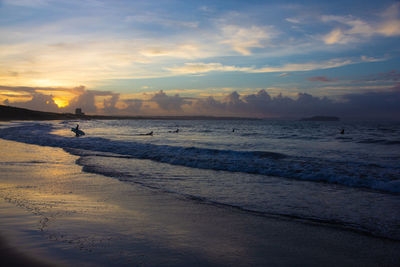 Scenic view of beach against sky during sunset