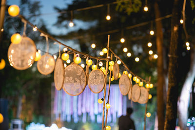 Illuminated lanterns hanging in city at night