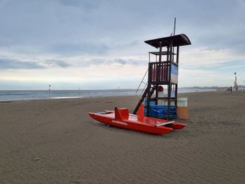 Lifeguard hut on beach against sky