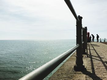 Rear view of man on sea against sky