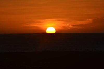 Scenic view of sea against orange sky