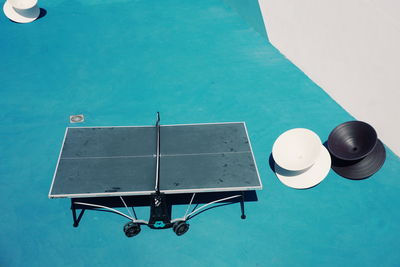 High angle view of empty table tennis at court during sunny day
