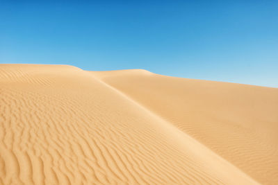 Scenic view of desert against clear sky