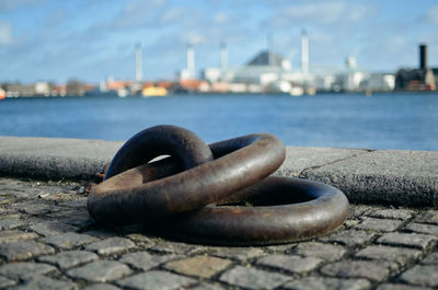 Close-up of rusty metal chain at harbor