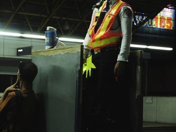 Midsection of woman standing in illuminated building