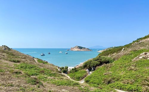 Scenic view of sea against clear blue sky