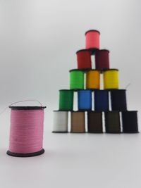 Close-up of multi colored pencils on table against white background