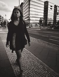 Woman standing on city street