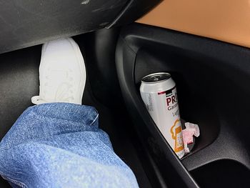 Low section of person sitting in car