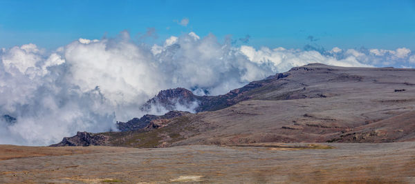 Smoke emitting from volcanic mountain against sky