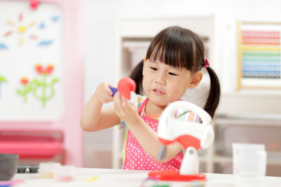 Young girl pretend playing food preparing at home 