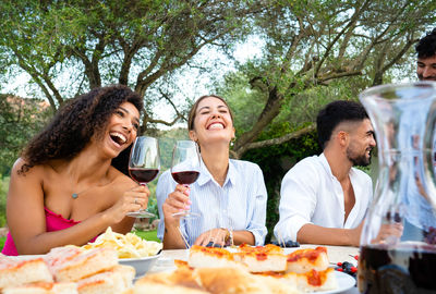 Group of friends drinking glass on table