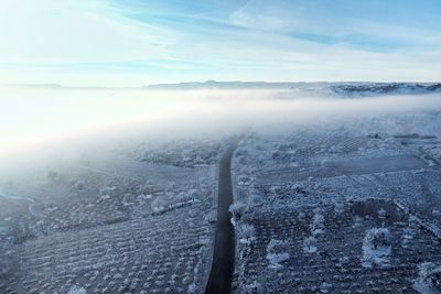 Aerial view of frozen landscape against sky