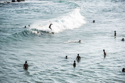 People bathing in the water at paciencia beach in salvador, bahia, brazil.