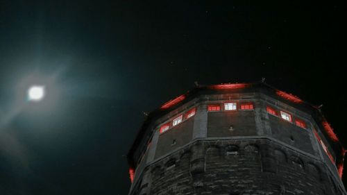 Low angle view of illuminated building at night