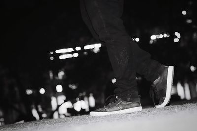 Low section of man on illuminated at night