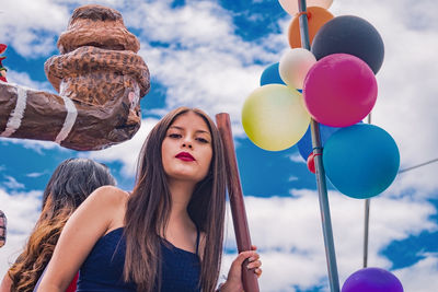 Portrait of woman holding balloons