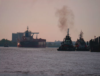 Ship sailing in sea against sky