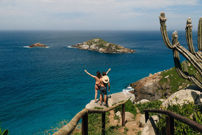 Couple standing against sea