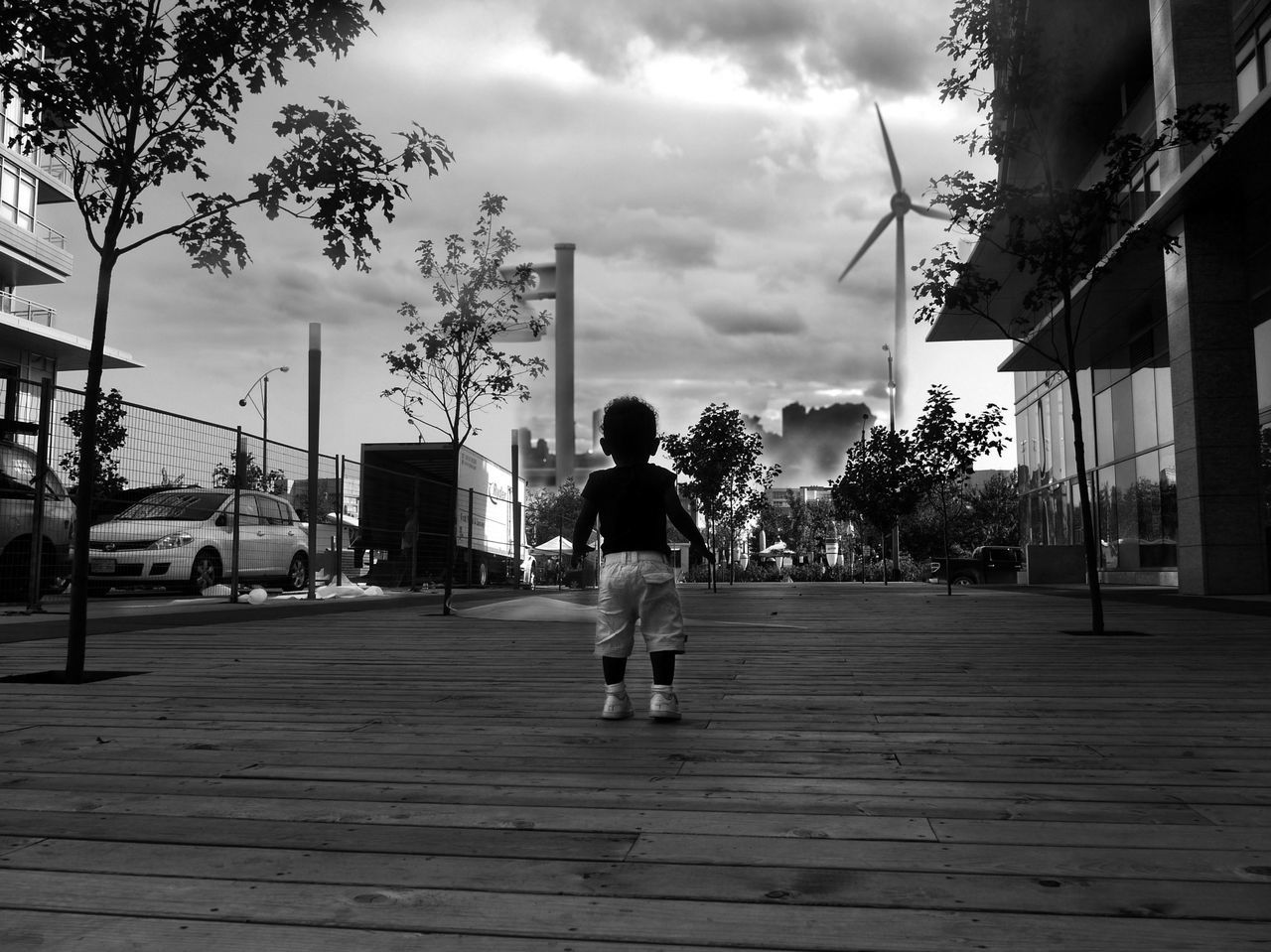 building exterior, sky, architecture, built structure, rear view, walking, full length, lifestyles, cloud - sky, men, the way forward, tree, person, leisure activity, city, street, cloud, cloudy