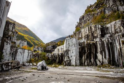 Carrara marble mine with unique patters and fall trees in italy.