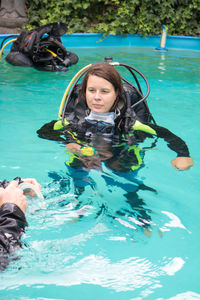 Woman wearing diving equipment while swimming in pool