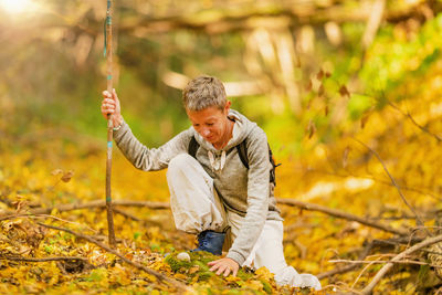 Mindful spiritually awakened woman exploring the forest, enjoying the nature. forest bathing concept