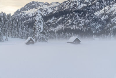 Scenic view of snow covered field against mountain