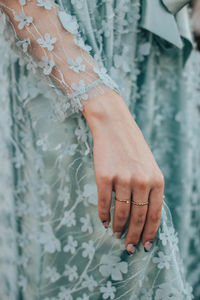 Close-up of woman hand on dress