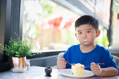 Portrait of boy eating food