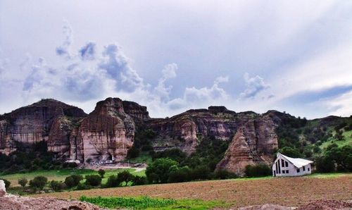 Scenic view of mountains against cloudy sky