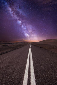 Road against sky at night