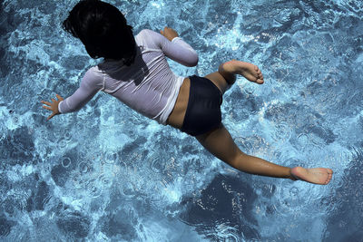 Woman jumping in water