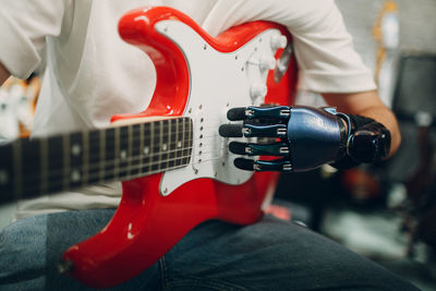 Close-up of man playing guitar