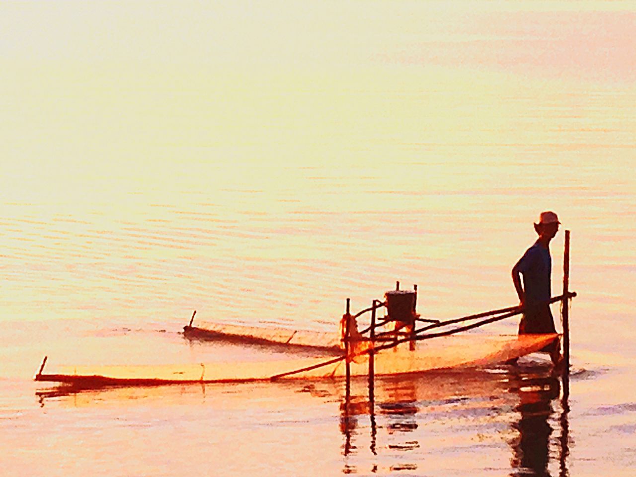 water, sunset, nautical vessel, boat, waterfront, transportation, rippled, sea, orange color, mode of transport, pier, reflection, silhouette, nature, tranquility, lake, built structure, outdoors, wood - material, one person