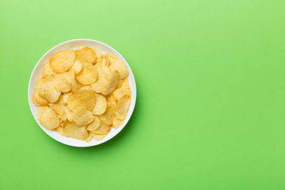 Directly above shot of food in bowl on yellow background