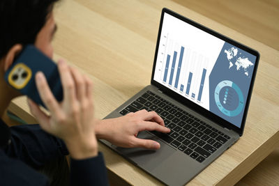 Midsection of woman using laptop