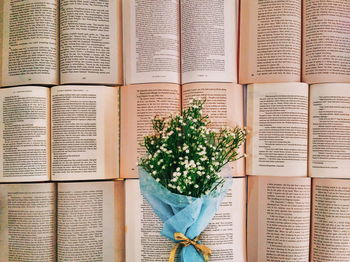Directly above shot of bouquet on open books