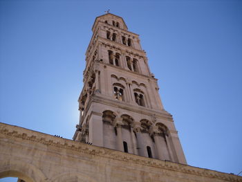 Low angle view of historic building against clear blue sky