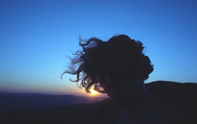 Portrait of silhouette woman against blue sea