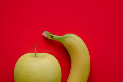 Close-up of apple against red background