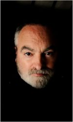 Close-up portrait of man against black background