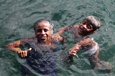 High angle view of smiling swimming in sea