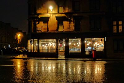 Reflection of illuminated buildings in city at night