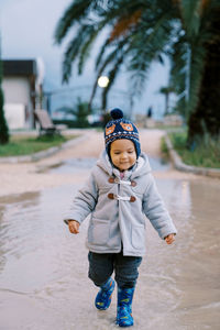 Portrait of boy standing on road